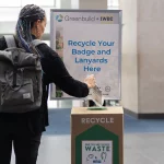 An attendee recycles a name badge and lanyard at Greenbuild & IWBC, the world’s largest event for green building professionals.